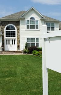 House with sign in front yard